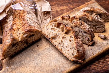 Pieces of buckwheat bread. Sliced baguette on a wooden board.