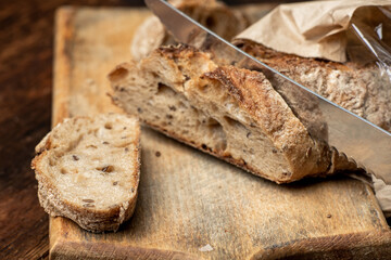 Pieces of buckwheat bread. Sliced baguette on a wooden board.