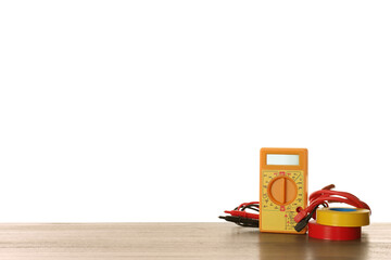 Digital multimeter and tapes on wooden table against white background. Electrician's supplies
