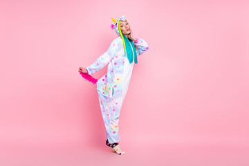 Full length body size view of attractive funny girl wearing kigurumi posing fooling isolated on pink pastel color background