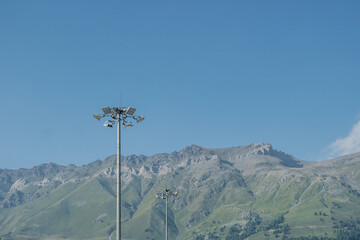 High masts with floodlights on the ski slope.