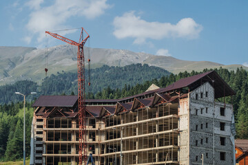 Hotel under construction in a ski resort in the summer.
