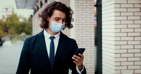 Close up shot of man entrepreneur using smartphone, surfing internet, texting messages, answering...
