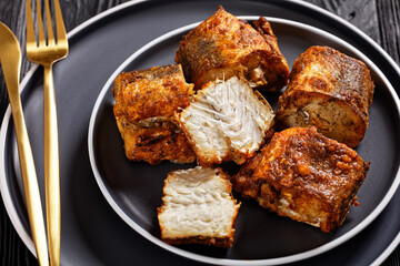fried pieces of hake on a plate