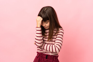 Little girl isolated on pink background with headache