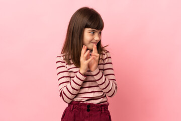 Little girl isolated on pink background scheming something