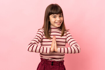 Little girl isolated on pink background keeps palm together. Person asks for something