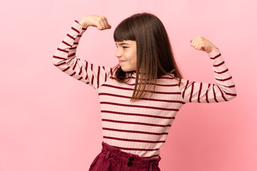 Little girl isolated on pink background doing strong gesture