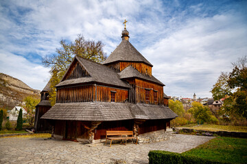 Fototapeta na wymiar Wooden church on an autumn day in Kamianets-Podilskyi.