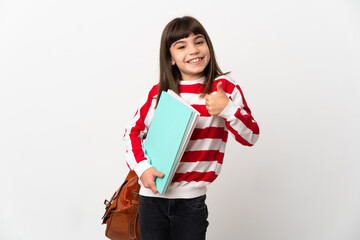 Little student girl isolated on white background giving a thumbs up gesture