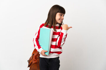 Little student girl isolated on white background pointing to the side to present a product