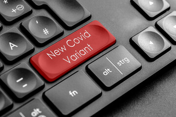 rote "New Covid Variant" Taste auf einer dunklen Tastatur