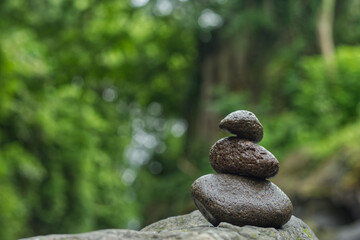 Stacked stones on the bank of the Opak river, Yogyakarta, Indonesia. Photo with the concept of harmony, wellness and balance with selective focus.