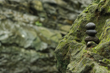 Stacked stones on the bank of the Opak river, Yogyakarta, Indonesia. Photo with the concept of harmony, wellness and balance with selective focus.