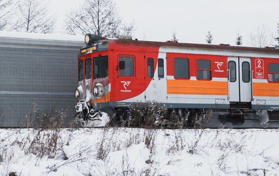 PKP class EN71 Polish EMU train of PolRegio, going fast in a snow winter scenery on January 17, 2021 in Krzeszowice, Poland.