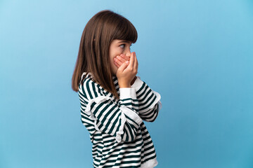 Little girl over isolated background covering mouth and looking to the side
