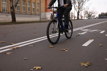 Man riding bicycle on lane in city, closeup