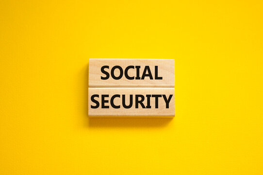 Time to social security symbol. Concept words Social security on wooden blocks on a beautiful yellow background. Business and social security concept. Copy space.