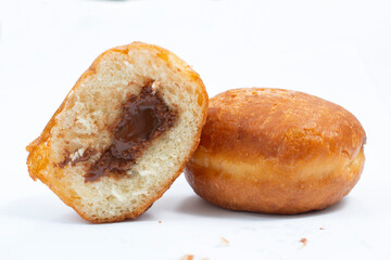 small round donuts with chocolate filling on white background