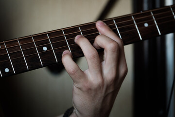 Fototapeta na wymiar Hand playing on a guitar.