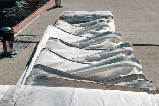 Rolled or folded sails for winter storage, sailmaking and maintenance