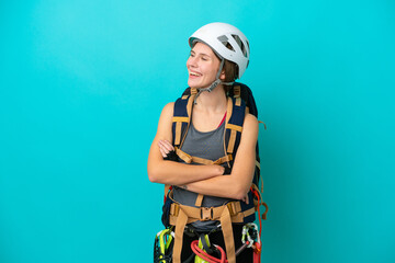 Young English rock climber woman isolated on blue background happy and smiling