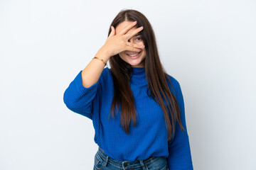Young Ukrainian woman isolated on white background covering eyes by hands and smiling