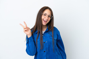 Young Ukrainian woman isolated on white background smiling and showing victory sign