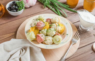 Childrens multicolored dumplings with meat on a white plate