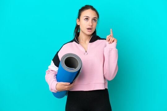 Sport Ukrainian woman going to yoga classes while holding a mat thinking an idea pointing the finger up