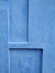 Bright blue wall of the house painted with calcimine