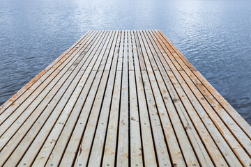 Fototapeta premium a free wooden pier made of equal parallel planks. empty space