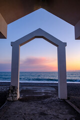 arch on the seashore at sunset time