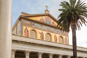 Obraz premium Exterior of the papal basilica of Saint Paul Outside the Walls in Rome, Italy. The facade above the colonnade is decorated with mosaics made in the 19th century.