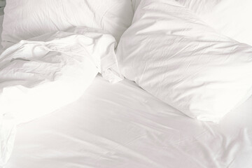 White comfort bed and soft pillow in bedroom. White blanket in hotel bedroom. Copy space