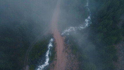 The fog over the hills is approaching. Drone footage