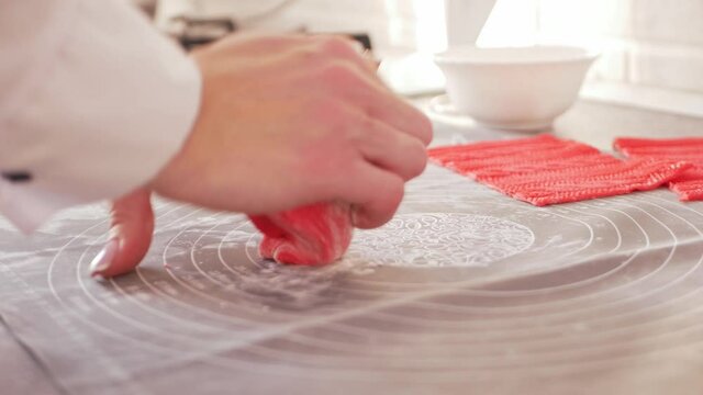 pastry chef makes mastic to decorate cake. Elastic dough, delicious pastries, cooking process. Home production, hobbies, entrepreneurship. kneads dough with hands