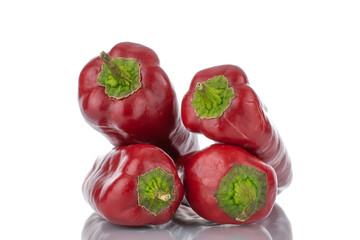 Four red bell peppers, close-up, isolated on white.