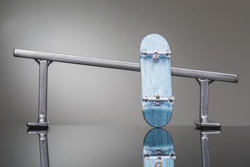 Fingerbord and metal railings of silver color on a gradient background