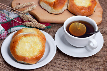 Sweet buns with cottage cheese and a cup of hot tea