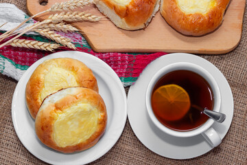 Sweet buns with cottage cheese and a cup of hot tea