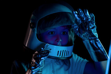 Kid boy exploring space. Portrait of cute kids in space suits. Cosmonautics day concept. Close up excited kids face on neon color. © Volodymyr