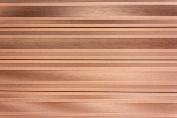 Background of light brown boards with grooves made of vertical tongue and groove boards