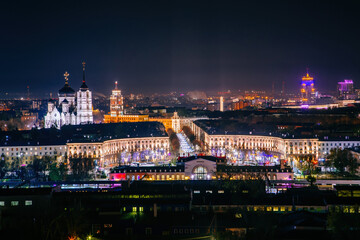 Fototapeta na wymiar Night Voronezh downtown. View to Voronezh railway station, Mira Street, South-eastern railway main building and Annunciation Cathedral