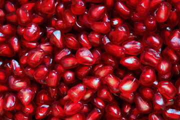 Red Background of Grain Red Grenades. Big Ripe Red Granets or Garnets. Fruits of Red Ripe Pomegranate. Vegetarian Concept, Organic Vitamins. Organic and Benefit Garnet Fruit.