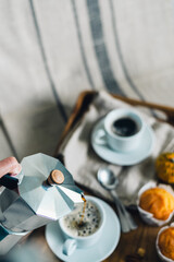 Morning coffee with pumpkin muffins on a wooden tray.