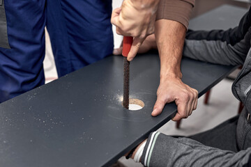 Handyman making kitchen wall cabinets in the apartment.