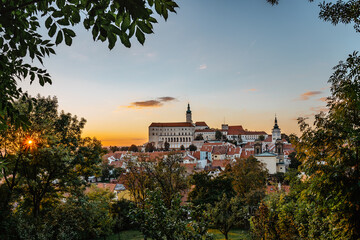 View of Mikulov with beautiful Baroque castle on the rock at sunset,south Moravia,Czech Republic.Dominant of town skyline.Czech Chateau in Palava wine region.Picturesque town among vineyards.