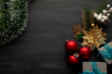 black wood with Christmas decoration of spheres with gifts and golden flowers
