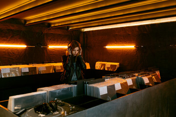 Woman listening to music in vinyl store